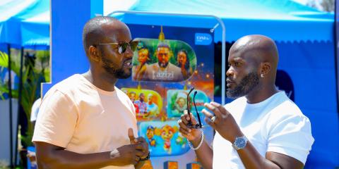 PIC 1   From L to R Elisha Kamau, Public Relations Manager at MultiChoice Kenya, engages in conversation with Alex Khayo, who plays Sting on Qware, during the MultiChoice Krisi Festival Activation at Nyayo Estate.