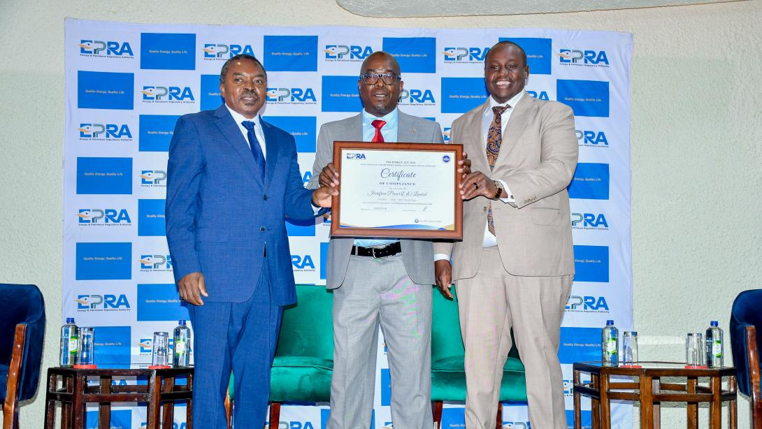 Eng Isaac Kiva, Secretary for Renewable Energy in the State Department of Energy(Left) joins Mr Daniel Kiptoo, Director General at the Energy and Petroleum Regulatory Authority(Right) to present a certificate of compliance on Energy Management to Mr Michael Nyangi , the Chief Financial Officer Iberaafrica Power (E.A) LTD.