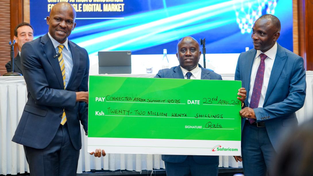 From right: Frankline Okata, Senior Executive, Safaricom PLC; Eng. John Tanui, CBS, Principal Secretary, State Department for ICT and the Digital Economy; and Jessy Kiveu Maruti, Chief Executive Officer, ICT Authority, during the presentation of a KES 22 million cheque at the Connected Africa Summit 2026 Media Briefing.