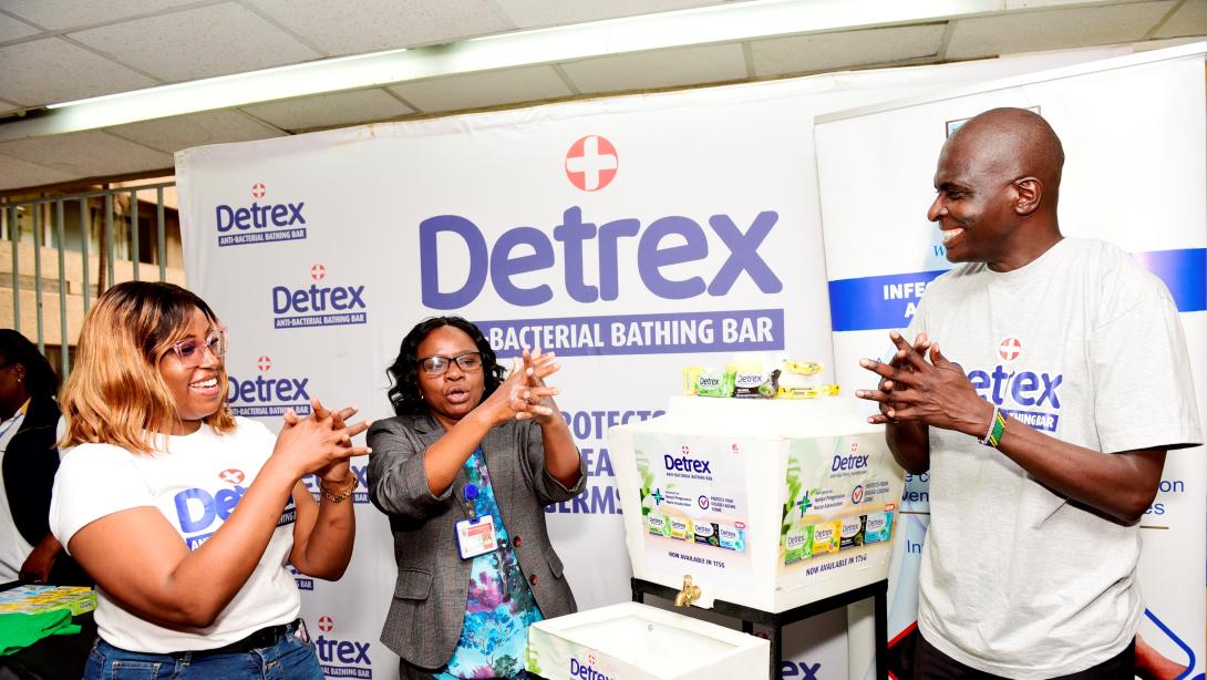 Pwani Oil's Detrex Brand Manager, Evah Kariuki, Sales Manager, Polycarp Nyawuana, hand over Detrex antibacterial soap to Jemimah Katama, Ag. Head of Infection Prevention and Control (IPC