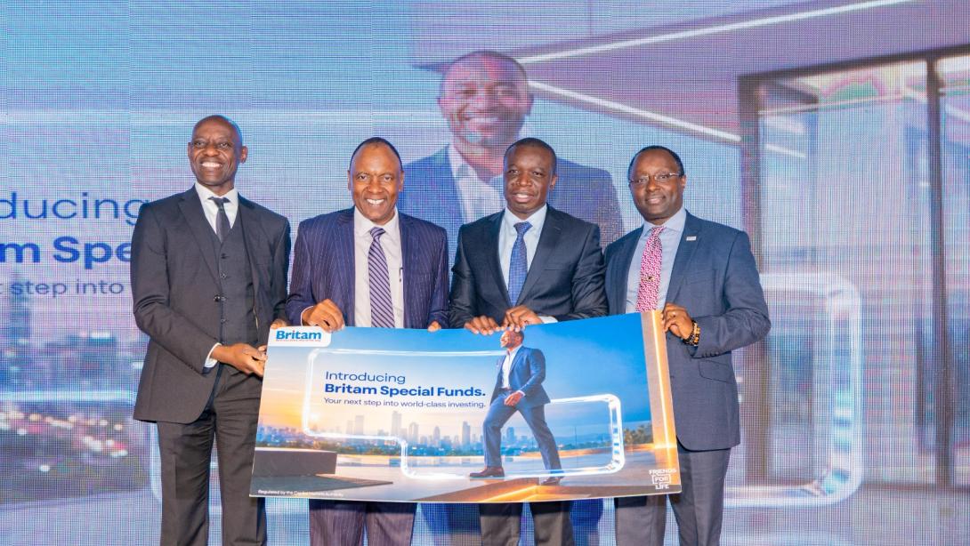 Four men hold a promotional board introducing Britam Special Funds during the launch of two investment funds in Nairobi.