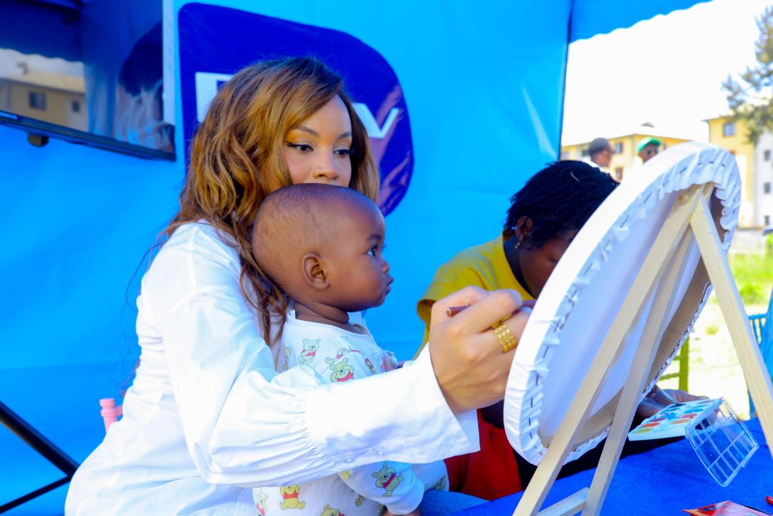 PIC 2   Brenda Wairimu, who plays Bri on Lulu, engages children in a fun paint and art session at the MultiChoice Krisi Festival Activation at Nyayo Estate