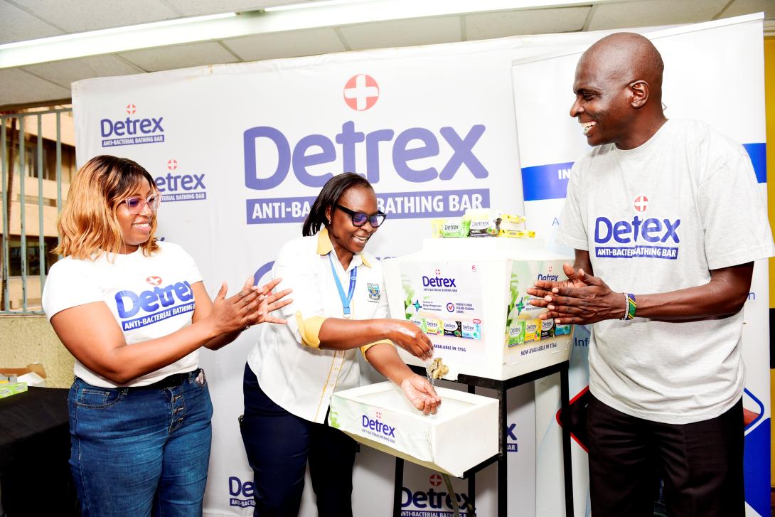 Pwani Oil's Detrex Brand Manager, Evah Kariuki, Sales Manager, Polycarp Nyawuana, hand over Detrex antibacterial soap to Jemimah Katama, Ag. Head of Infection Prevention and Control (IPC