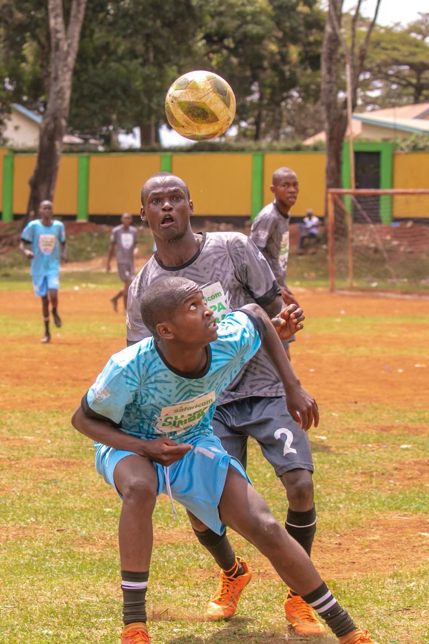Mbuthani Secondary School from Makueni (black) in action against Black Cats Football Academy from Embu (blue) during the Season Five of the Safaricom Chapa Dimba Eastern Region Playoffs at Nembure Grounds in Embu.